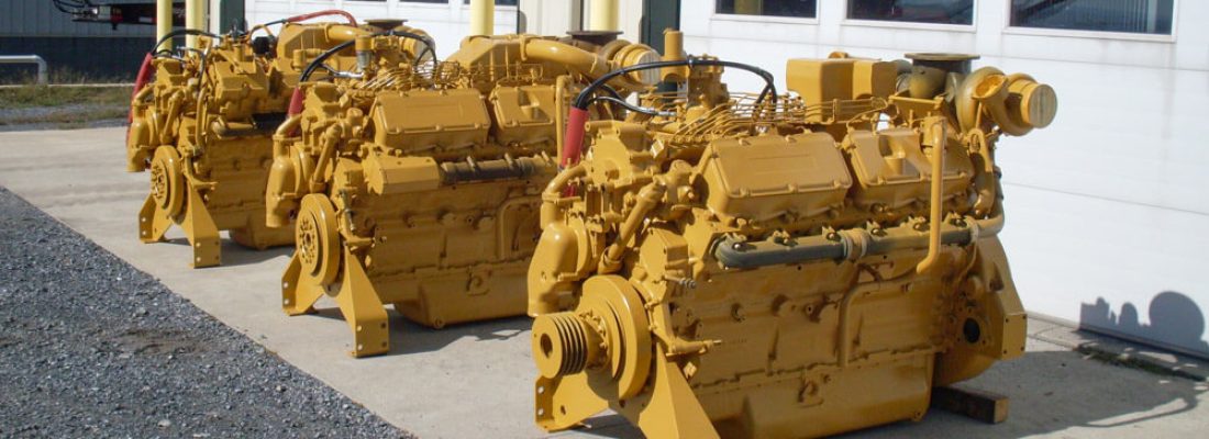 Three Cat engines in front of the shop